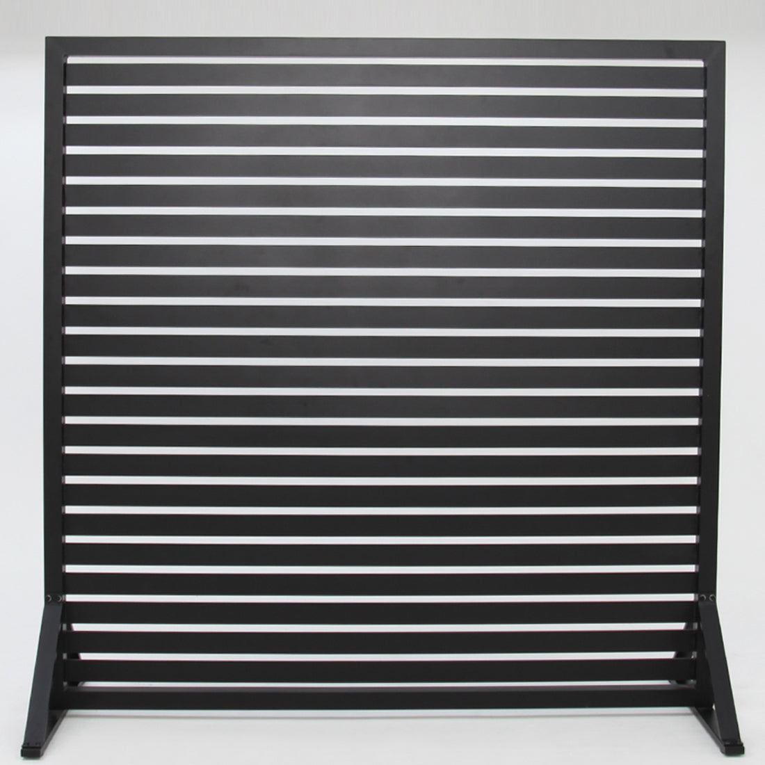Black outdoor privacy screen sheltering an alfresco area
