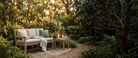 Timber garden bench styled with cushions and candle lanterns in a spring garden