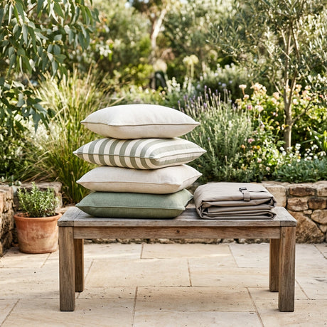 Stack of outdoor cushions on a timber bench