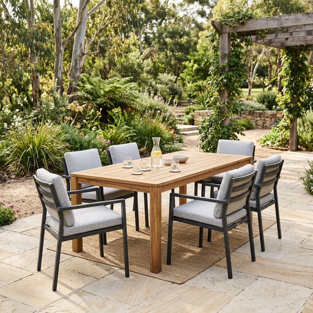 Outdoor dining setting with timber table and cushioned chairs on an alfresco patio